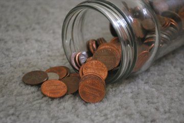 Pennies falling out of a glass jar